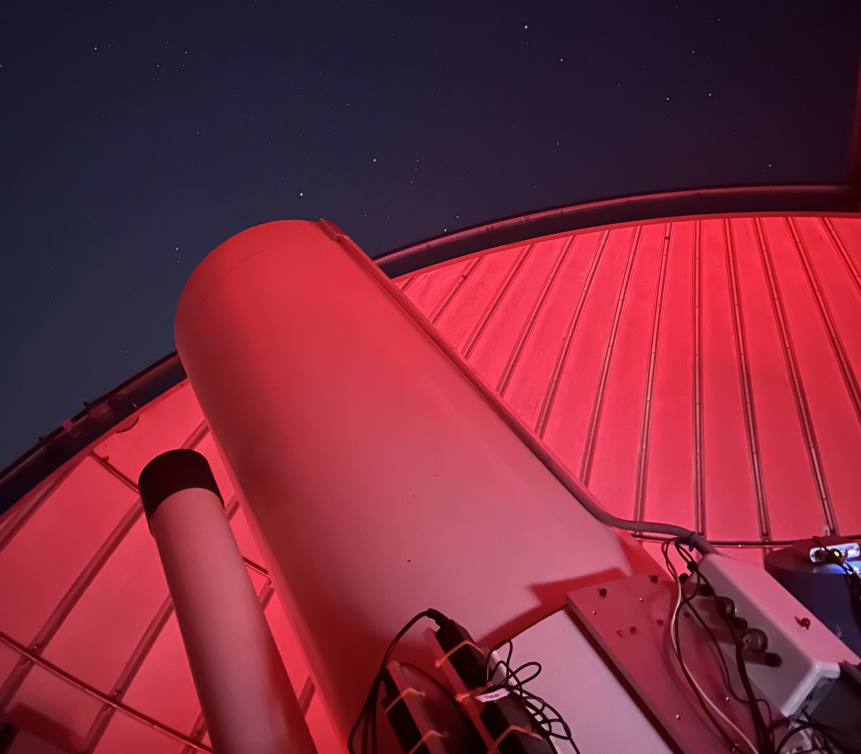 The 24 inch telescope pointing out an open dome.