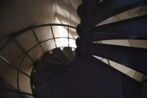 Looking down from a dark spiral staircase.