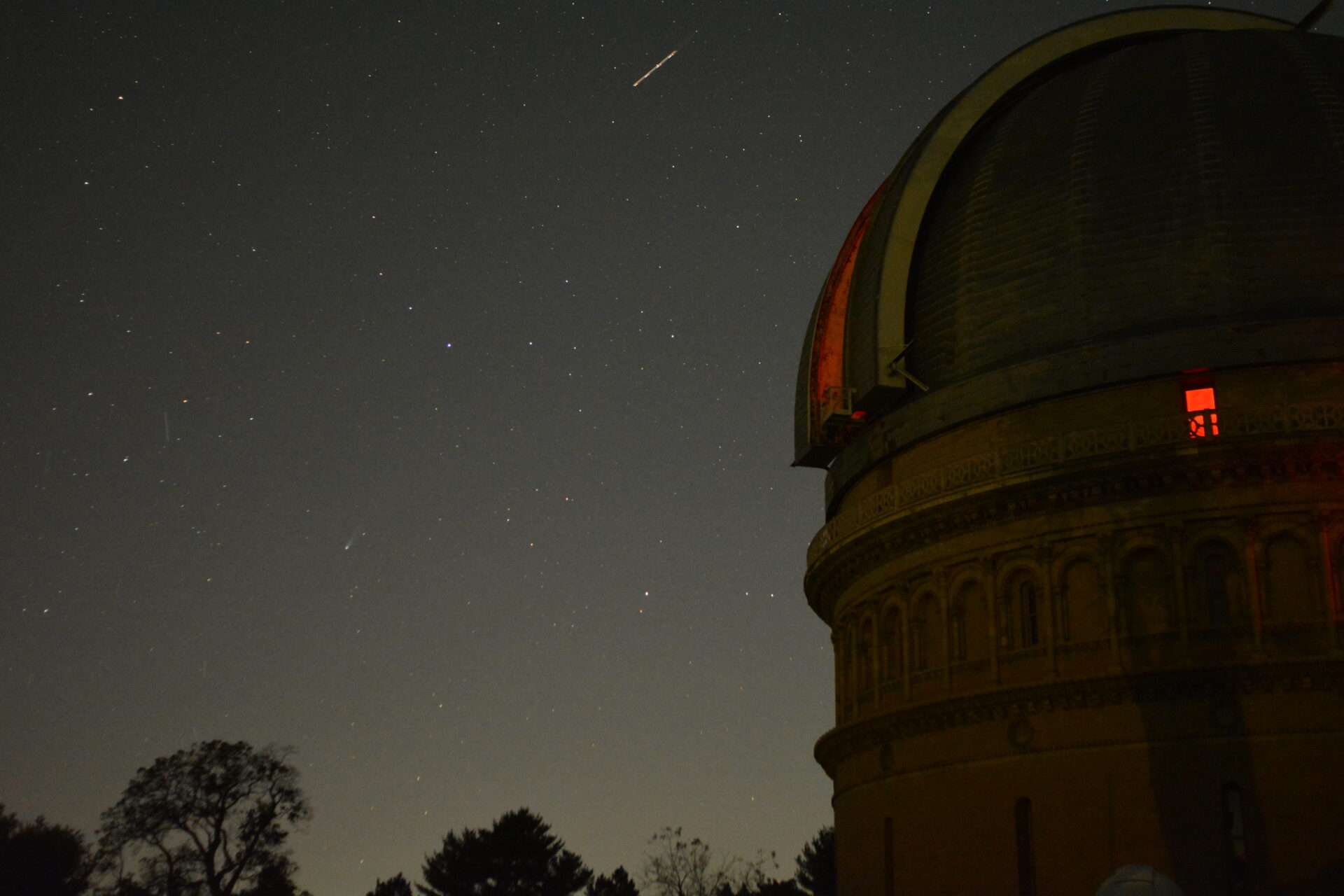 Yerkes Observatory at night with the shutter open and a starry sky in the background