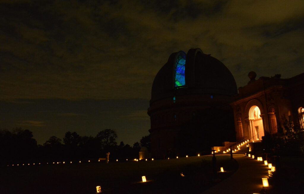 Yerkes Observatory at night with lit pathways.